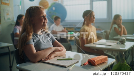 Team of Smart Diverse Kids Sitting at Desks, Studying Ecology, Listening to Lecture from Teacher Team of Smart Diverse Kids Sitting at Desks, Studying Ecology, Listening to Lecture from Teacher 128870437