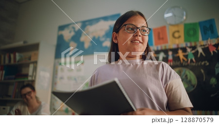 Renewable Energy Lesson: Elementary School Girl Speaking, Giving Presentation in Front of Classmates Renewable Energy Lesson: Elementary School Girl Speaking, Giving Presentation in Front of Classmates 128870579