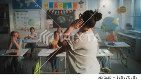 Cheerful Diverse Kids Clapping Their Hands, Interacting with Teacher During Dynamic Gamified Activity 128870585