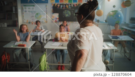 Cheerful Diverse Kids Clapping Their Hands, Interacting with Teacher During Dynamic Gamified Activity 128870604