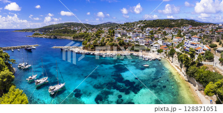 Idyllic Greek islands - Alonissos, Sporades. Charming village Votsi with beautiful bay and beach popular port for sailboats. Greece travel Idyllic Greek islands - Alonissos, Sporades. Charming village Votsi with beautiful bay and beach popular port for sailboats. Greece travel 128871051