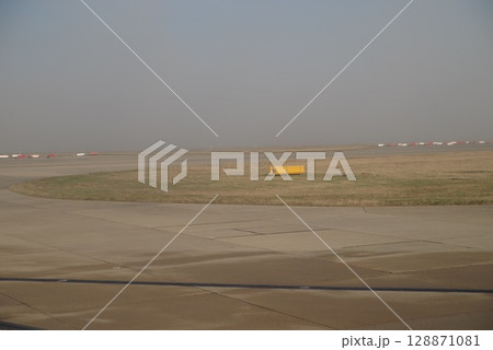 Yellow sign sits in the middle of a dry, dusty field Yellow sign sits in the middle of a dry, dusty field 128871081