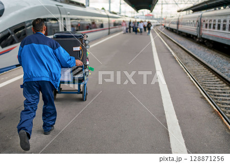 Luggage Handling on a High-Speed Railway Platform Luggage Handling on a High-Speed Railway Platform 128871256
