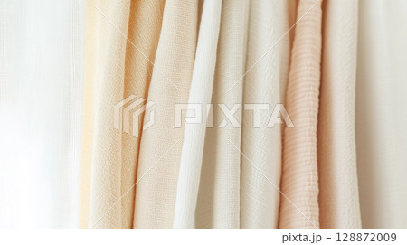 Light pastel clothes in soft textures create warm and inviting background 128872009