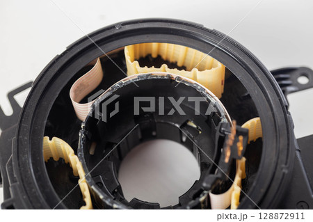 disassembled broken steering column electrical cable on white background, isolate, close-up 128872911