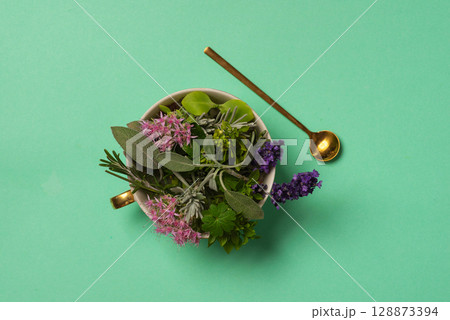 Assorted Fresh Herbs Bouquet In A Cup On Teal Background Assorted Fresh Herbs Bouquet In A Cup On Teal Background 128873394