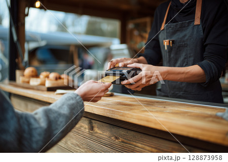 A woman is paying for her food at a counter 128873958