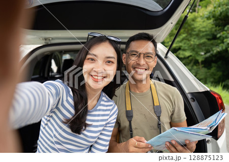 Couple enjoying road trip adventure, taking selfies and exploring Couple enjoying road trip adventure, taking selfies and exploring 128875123