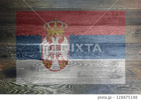 Serbia flag on rustic old wood surface background Serbia flag on rustic old wood surface background 128875198