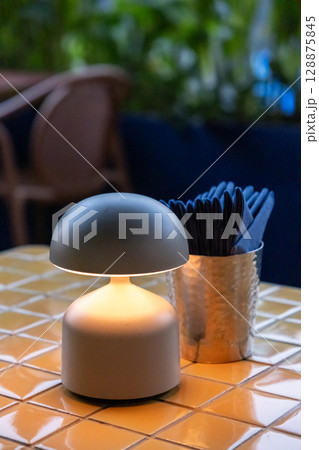 Table lamp with tissue paper on the table, in fine dining restaurant Table lamp with tissue paper on the table, in fine dining restaurant 128875845