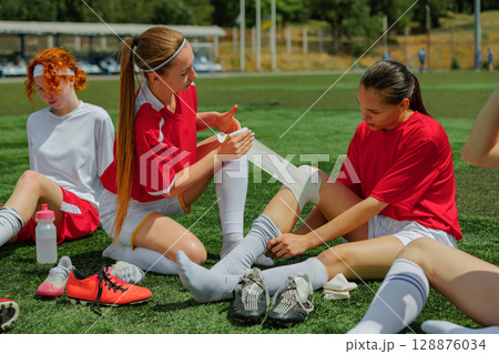 Young women soccer players encouraging one another on a sunny day on the field 128876034