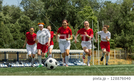 Female soccer athletes competing on outdoor field Female soccer athletes competing on outdoor field 128876040