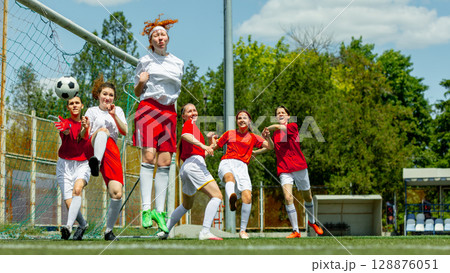 Female soccer players in goalmouth action during intense match Female soccer players in goalmouth action during intense match 128876051