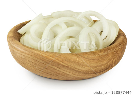 Onion slices in a wooden bowl isolated on a white background. Onion slices in a wooden bowl isolated on a white background. 128877444