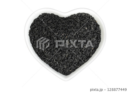 Nigella sativa or Black cumin in ceramic bowl isolated on white background. Top view. Flat lay. Nigella sativa or Black cumin in ceramic bowl isolated on white background. Top view. Flat lay. 128877449