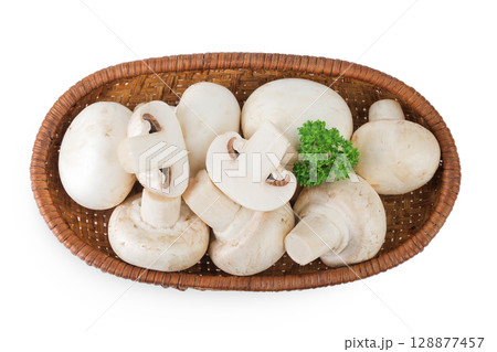 Fresh mushroom champignon in a wicker basket isolated on white background. Top view. Flat lay. Fresh mushroom champignon in a wicker basket isolated on white background. Top view. Flat lay. 128877457