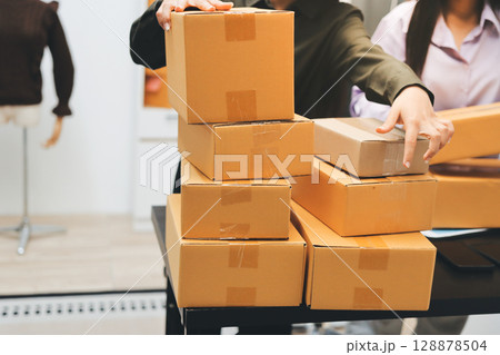 Portrait of Starting small businesses SME owners, two Asian woman check online orders Selling products working with boxs freelance work at home office, sme business online small medium enterprise 128878504
