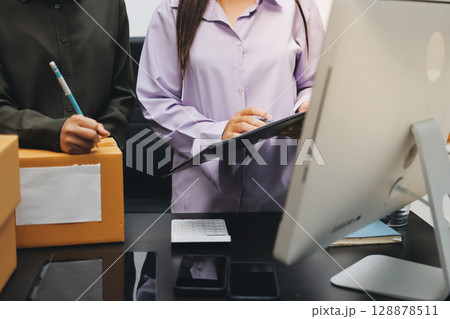 Portrait of Starting small businesses SME owners, two Asian woman check online orders Selling products working with boxs freelance work at home office, sme business online small medium enterprise Portrait of Starting small businesses SME owners, two Asian woman check online orders Selling products working with boxs freelance work at home office, sme business online small medium enterprise 128878511