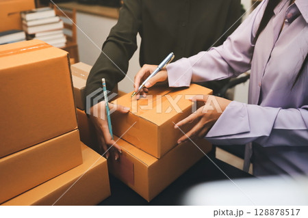 Portrait of Starting small businesses SME owners, two Asian woman check online orders Selling products working with boxs freelance work at home office, sme business online small medium enterprise Portrait of Starting small businesses SME owners, two Asian woman check online orders Selling products working with boxs freelance work at home office, sme business online small medium enterprise 128878517