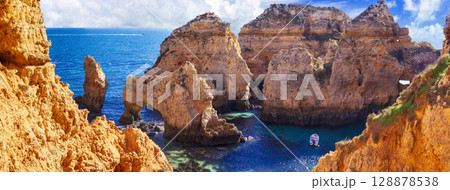 Amazing rocky scenic becahes of Algarve coast, Portugal. Breathtaking famous beach Praia da Marinha Amazing rocky scenic becahes of Algarve coast, Portugal. Breathtaking famous beach Praia da Marinha 128878538