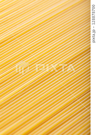 Raw Spaghetti Noodles in Diagonal Food Background Macro Shot Raw Spaghetti Noodles in Diagonal Food Background Macro Shot 128878700