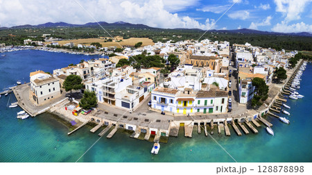Mallorca island landmarks. Scenic fishing village Portocolom with colorful houses and boats . Popular tourist destination. Balears, Spain. Mallorca island landmarks. Scenic fishing village Portocolom with colorful houses and boats . Popular tourist destination. Balears, Spain. 128878898