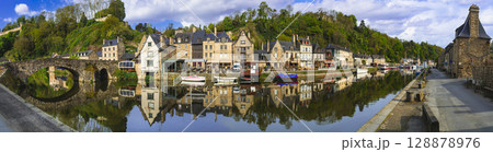 France travel, most scenic villages and romantic towns of Brittany. Picturesque traditional port of Dinan with half-timbered houses, restaurants over canals France travel, most scenic villages and romantic towns of Brittany. Picturesque traditional port of Dinan with half-timbered houses, restaurants over canals 128878976