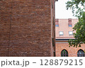 Brick Wall and Tiled Roof of an Old European Building 128879215