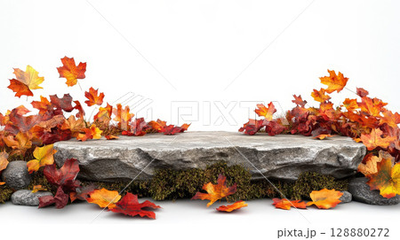 stone podium is beautifully displayed with vibrant autumn leaves scattered around, creating natural and seasonal atmosphere. earthy tones and textures evoke warm and rustic charm. 128880272