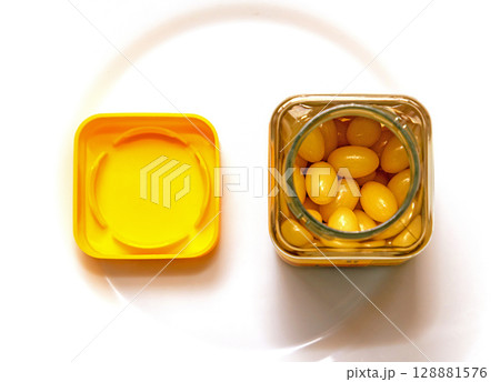 Yellow gel pills inside bottle Yellow gel pills inside bottle 128881576