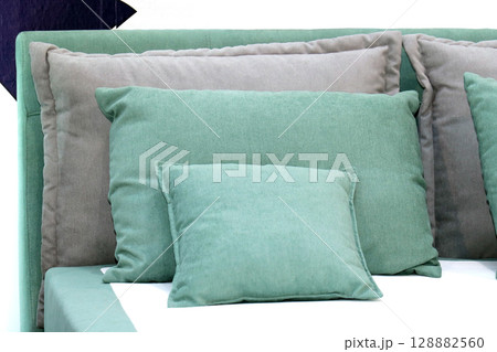 Textile pillows on bed 128882560