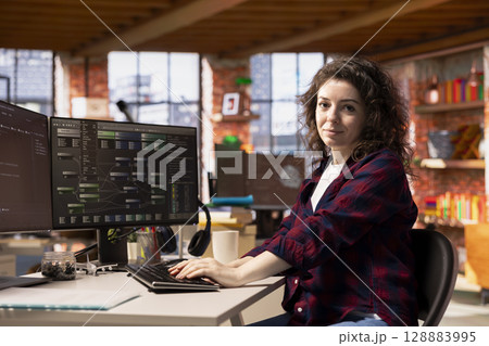 Portrait of smiling programmer coding advanced AI algorithm in startup workspace, refining machine learning models to enhance automation. Happy woman using coding platform in Silicon Valley office Portrait of smiling programmer coding advanced AI algorithm in startup workspace, refining machine learning models to enhance automation. Happy woman using coding platform in Silicon Valley office 128883995