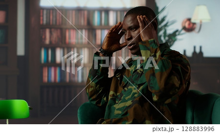 African american soldier remembering war flashbacks and dealing with a serious case of shell shock syndrome, traumatic memories. Armed forces veteran feels guilty with PTSD. Camera B. 128883996
