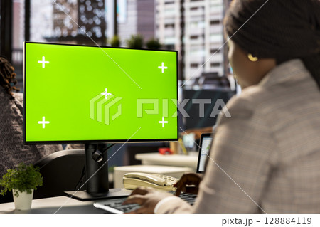 Professional employee analyzing business data on pc next to copy space screen, financial planning and budgeting supports company goals. Effective general management within the enterprise. 128884119