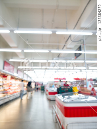 Blurred view of modern supermarket store background. Shopping in hypermarket superstore defocused bokeh light background. Blurred view of modern supermarket store background. Shopping in hypermarket superstore defocused bokeh light background. 128884279