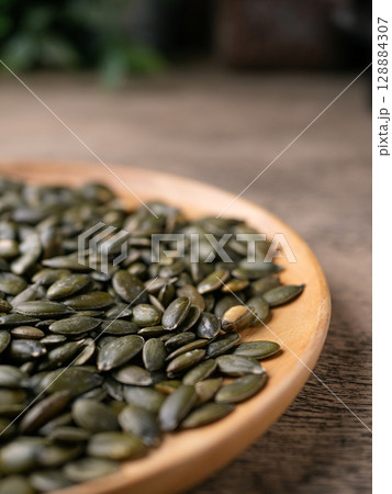 Peeled dry pepita pumpkin seeds background. Peeled dry pepita pumpkin seeds background. 128884307