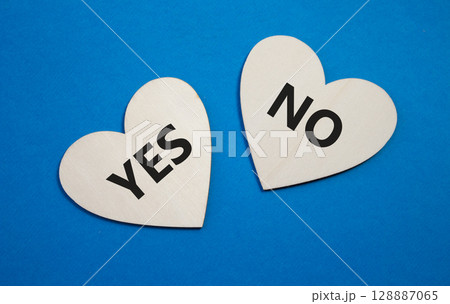 Yes or No symbol. Concept word Yes or No on wooden hearts. Beautiful blue background. Business and Yes or No concept. Copy space 128887065