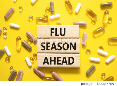Flu Season Ahead symbol. Concept word Flu Season Ahead on wooden blocks. Beautiful yellow background with pills. Medicine and Flu Season Ahead concept. Copy space Flu Season Ahead symbol. Concept word Flu Season Ahead on wooden blocks. Beautiful yellow background with pills. Medicine and Flu Season Ahead concept. Copy space 128887709