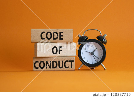Code of conduct symbol. Wooden blocks with words Code of conduct with alarm clock. Beautiful orange background. Business and Code of conduct concept. Copy space. 128887719
