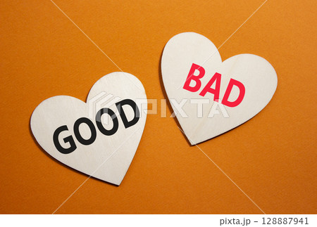 Good or Bad symbol. Concept word Good or Bad on wooden hearts. Beautiful orange background. Business and Good or Bad concept. Copy space 128887941