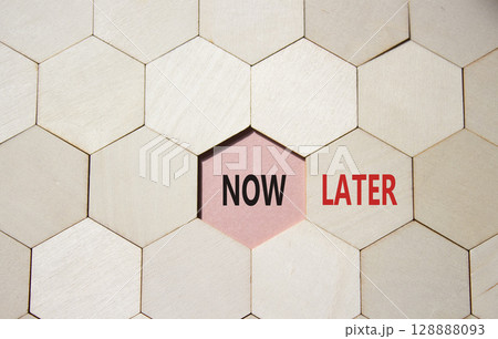 Now vs Later symbol. Concept word Now vs Later on wooden comb puzzle. Beautiful pink background. Business and Now vs Later concept. Copy space Now vs Later symbol. Concept word Now vs Later on wooden comb puzzle. Beautiful pink background. Business and Now vs Later concept. Copy space 128888093