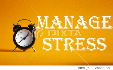 Manage stress symbol. Concept word Manage stress on Beautiful orange background with alarm clock. Medicine and Manage stress concept. Copy space 128888099