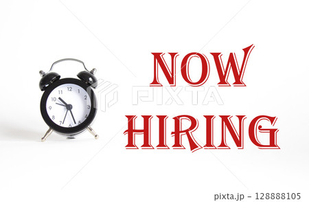Now Hiring symbol. Concept word Now Hiring on Beautiful white background with alarm clock. Business and Now Hiring concept. Copy space Now Hiring symbol. Concept word Now Hiring on Beautiful white background with alarm clock. Business and Now Hiring concept. Copy space 128888105