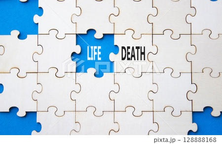 Life or Death symbol. Concept word Life or Death on wooden puzzle. Beautiful blue background. Business and Life or Death concept. Copy space 128888168