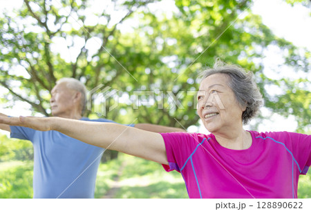 Happy asian senior couple exercising in the park. Happy asian senior couple exercising in the park. 128890622