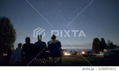 Family stargazing on camping trip 128891011