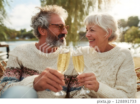 Couple celebrating anniversary with champagne outdoors 128891733