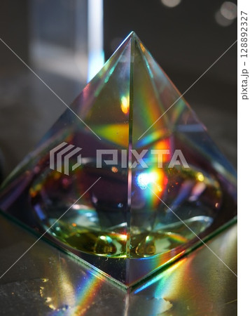 Glass pyramid with a rainbow inside 128892327
