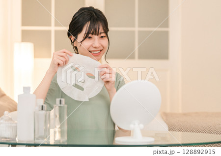 夜にフェイスパックを使う若いアジア人女性（スキンケア,シートマスク,ナイトケア） 128892915