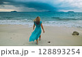 Charming woman with blonde curly long hair walk in beach, in stormy morning rain cloudy sea. Concept resort outdoor relax summer vacation, travel Charming woman with blonde curly long hair walk in beach, in stormy morning rain cloudy sea. Concept resort outdoor relax summer vacation, travel 128893254